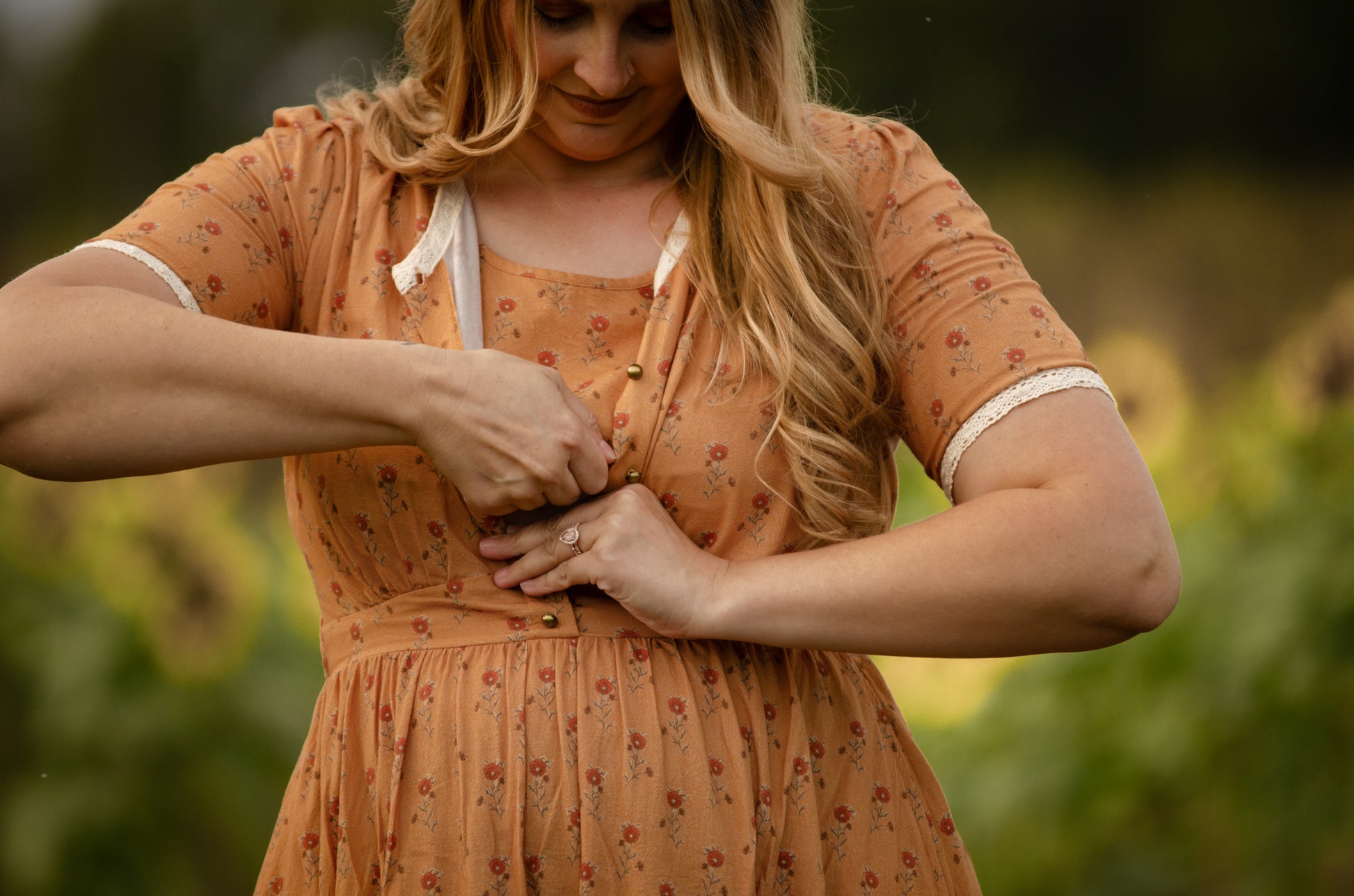 Woman in modest nursing dress adjusting dress outdoors