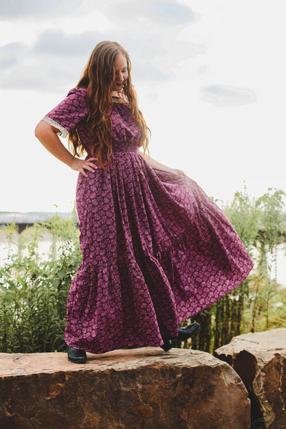 Woman in modest purple nursing dress outdoors