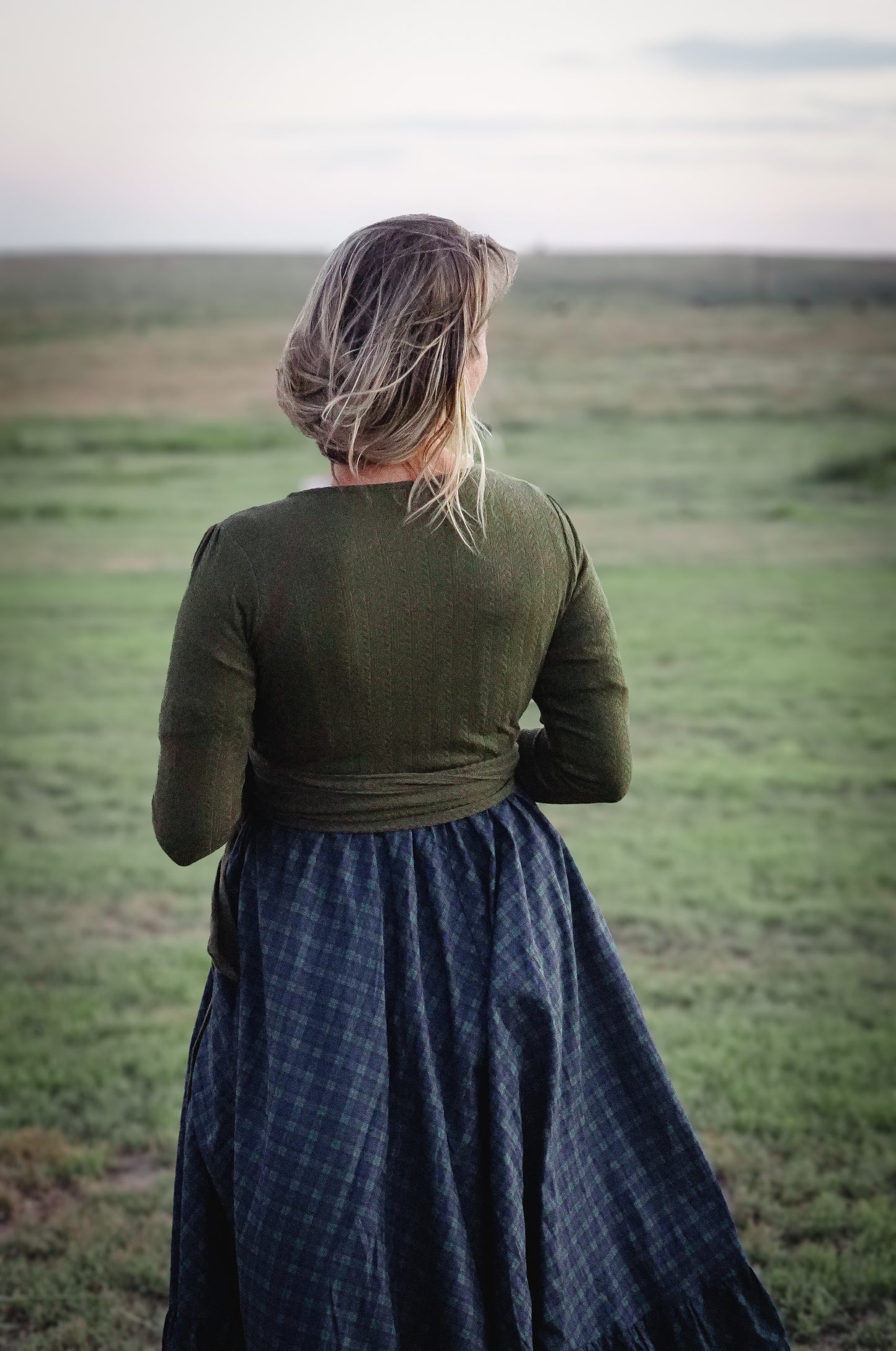 Woman in modest nursing wrap and plaid skirt