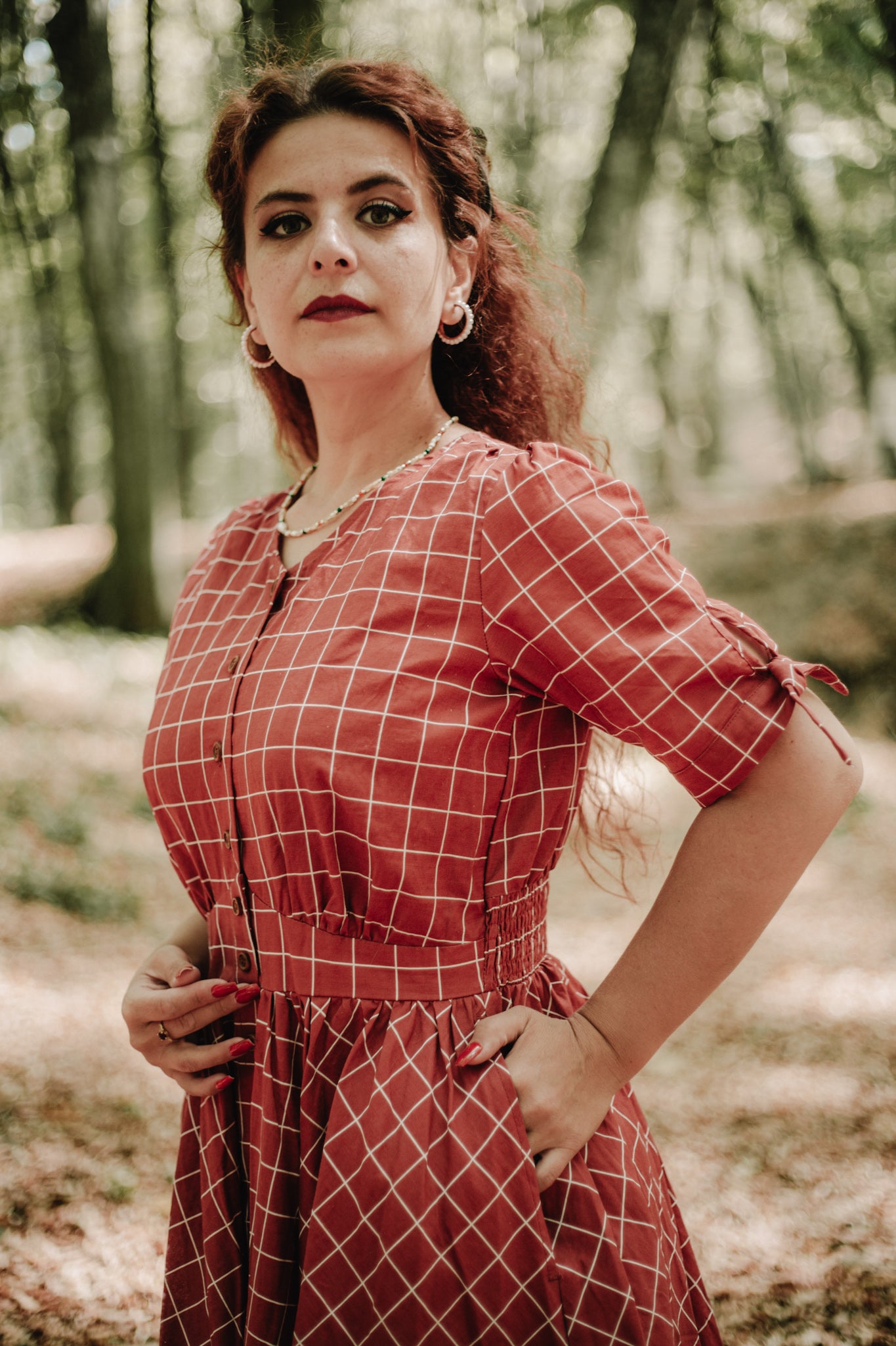 Woman in modest nursing red checkered dress forest
