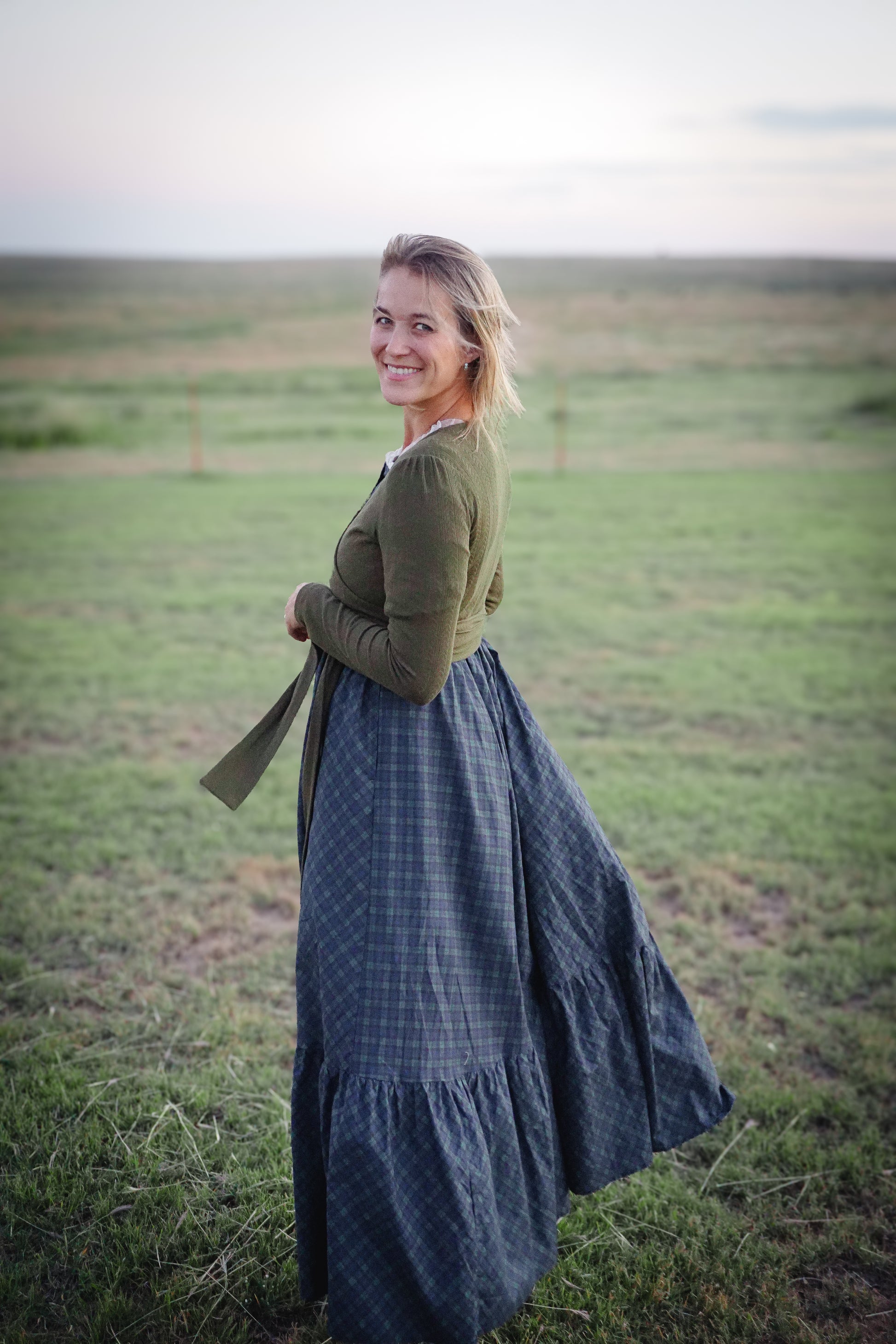 Woman in modest nursing wrap and plaid skirt