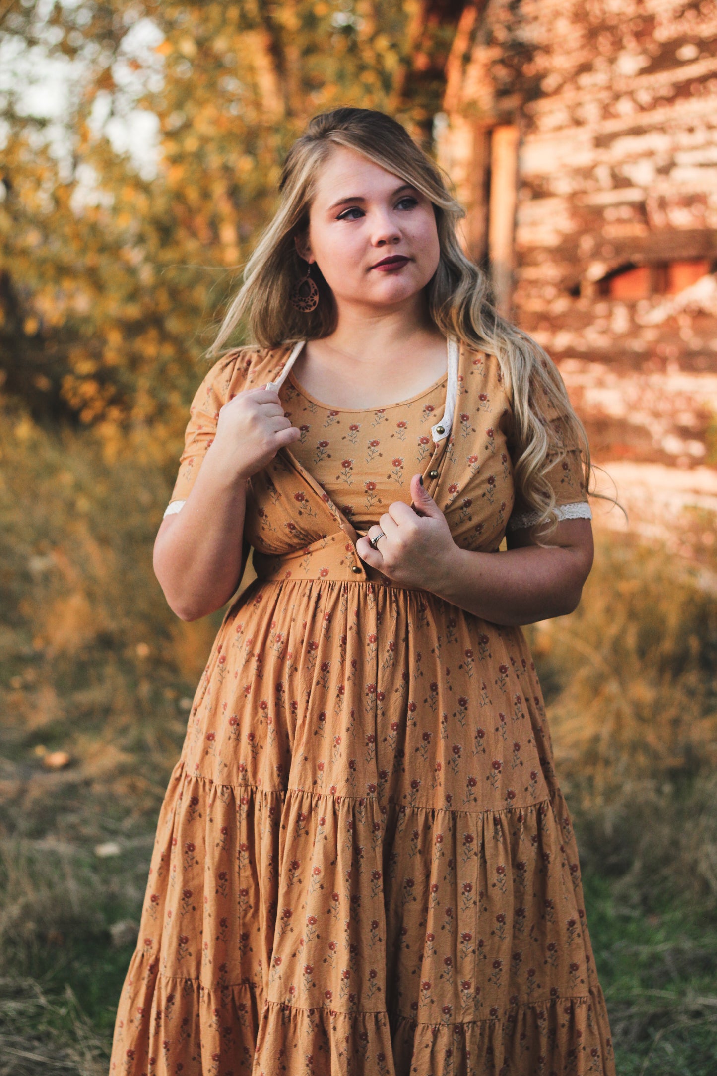 Woman modest nursing dress outdoors trees stone wall