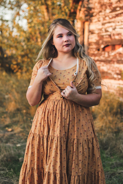 Woman modest nursing dress outdoors trees stone wall