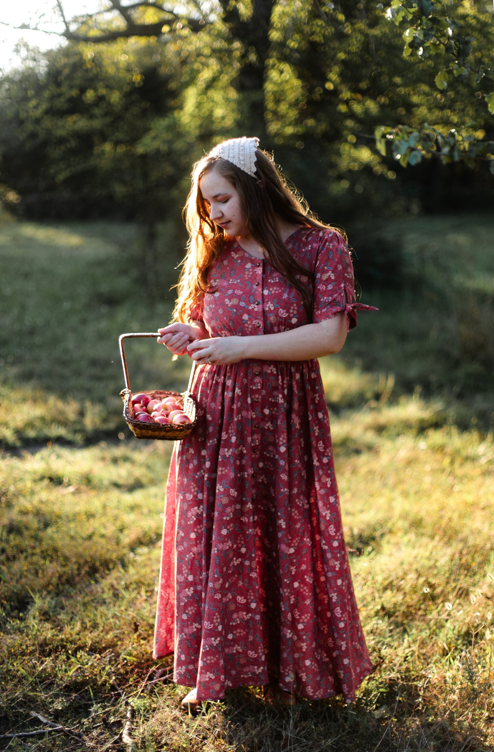 Woman in modest nursing red floral dress outdoors