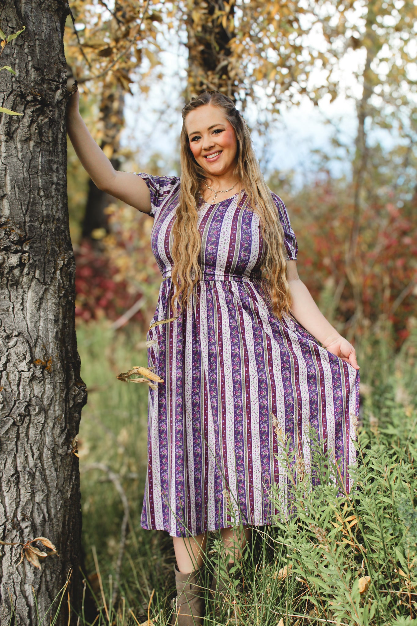 Woman in modest nursing purple striped dress outdoors