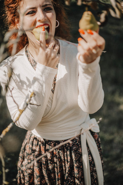 Woman in modest nursing dress holding bird outdoors