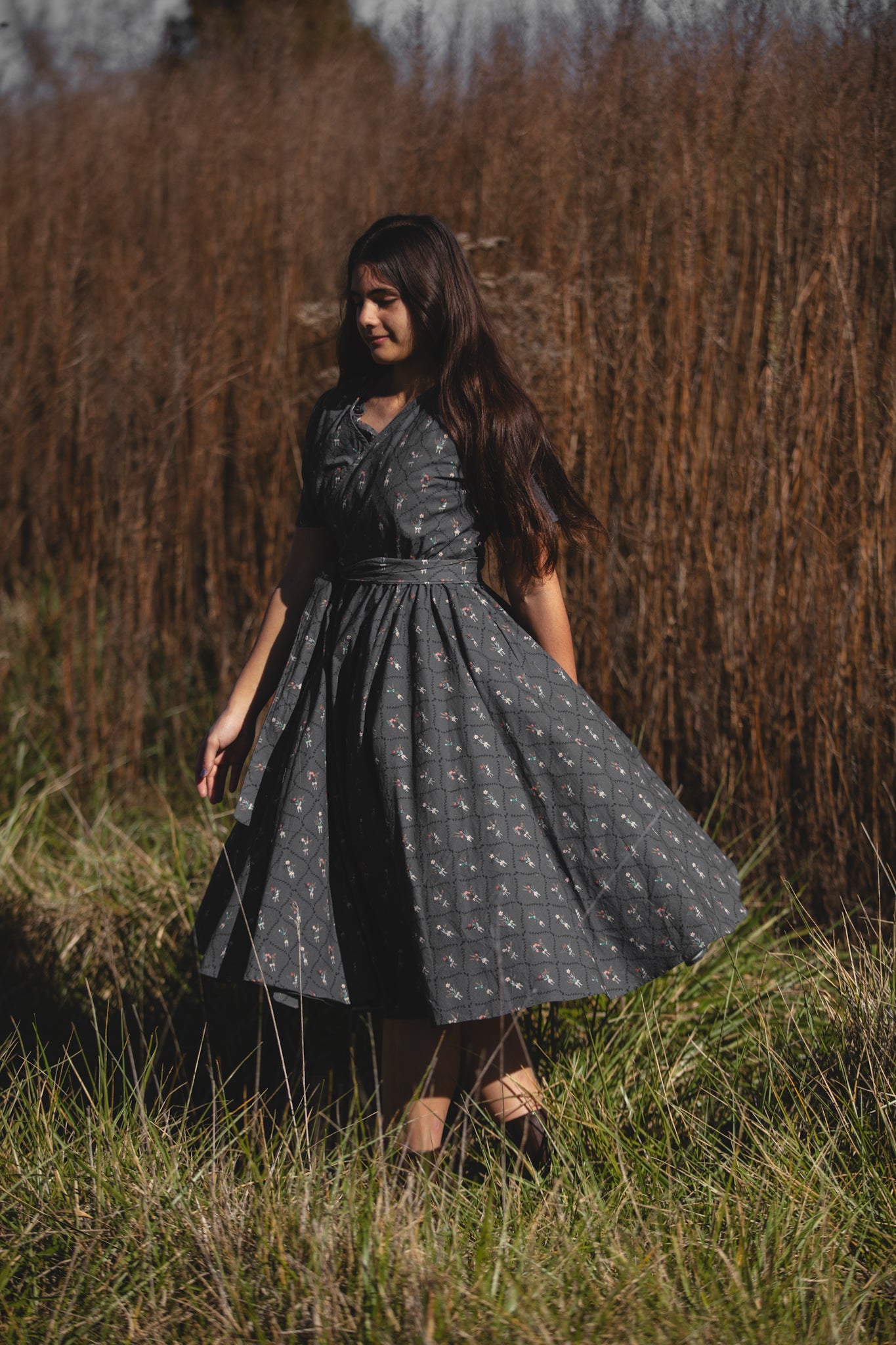 Modest nursing-friendly dark dress in field