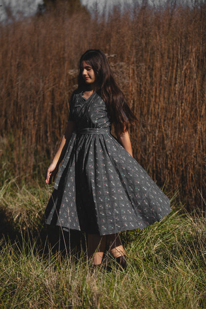 Modest nursing-friendly dark dress in field