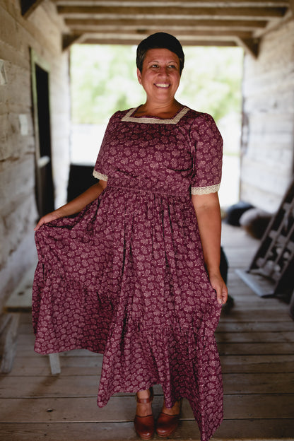 Woman in modest floral nursing dress on porch