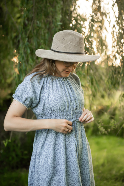 woman in a modest blue nursing dress