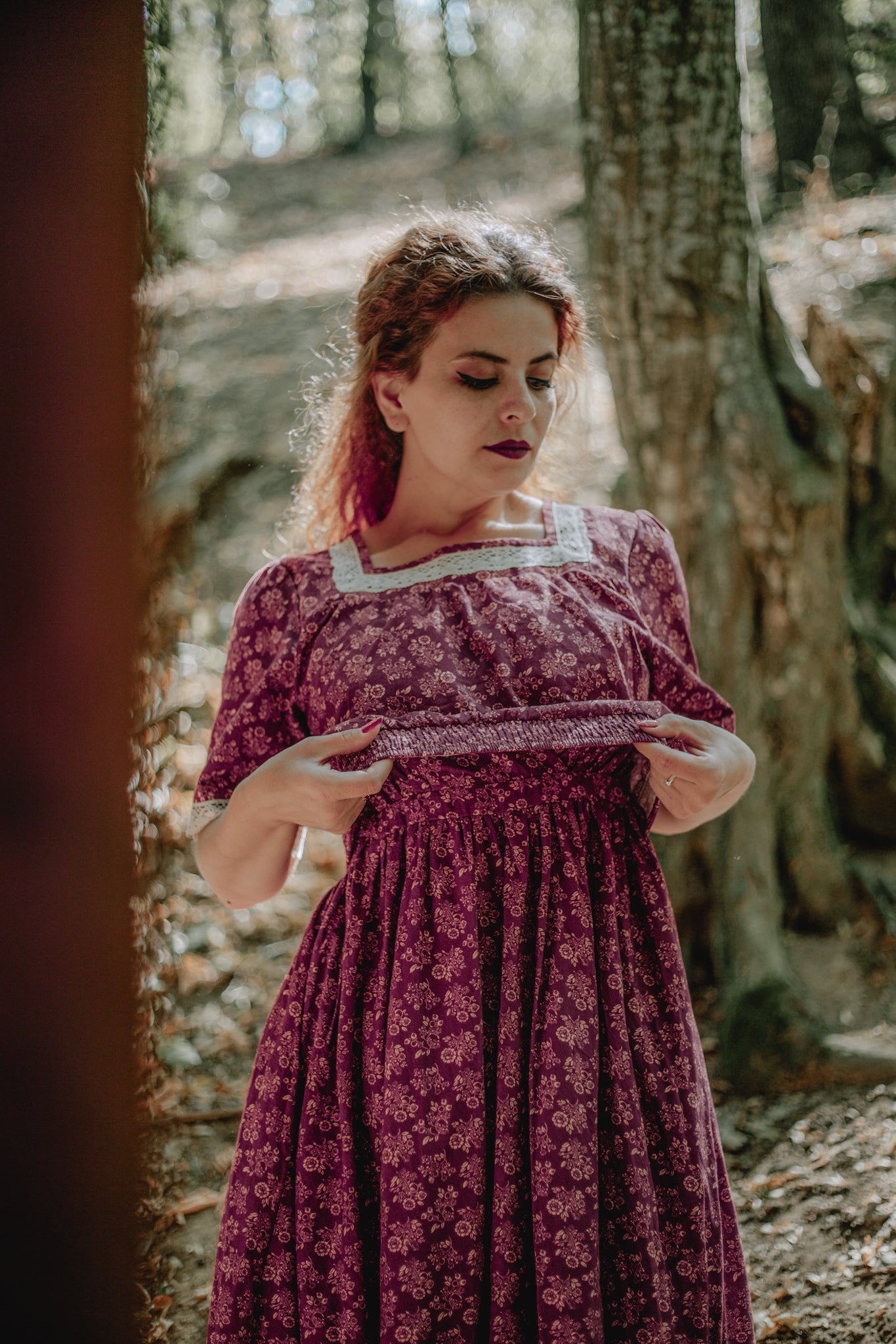 Woman in modest nursing dress standing in forest