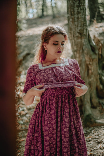 Woman in modest nursing dress standing in forest