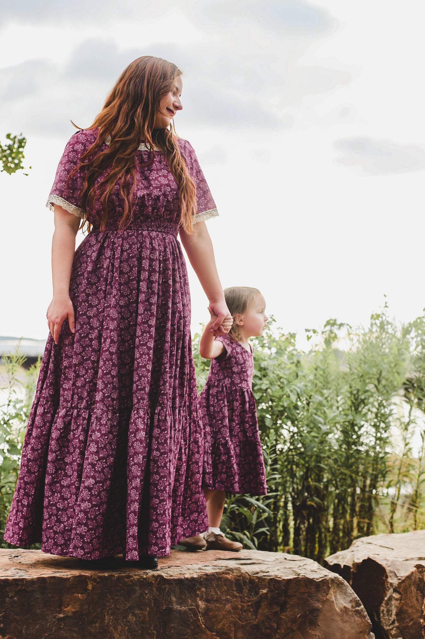 Two women wearing modest nursing dresses outdoors
