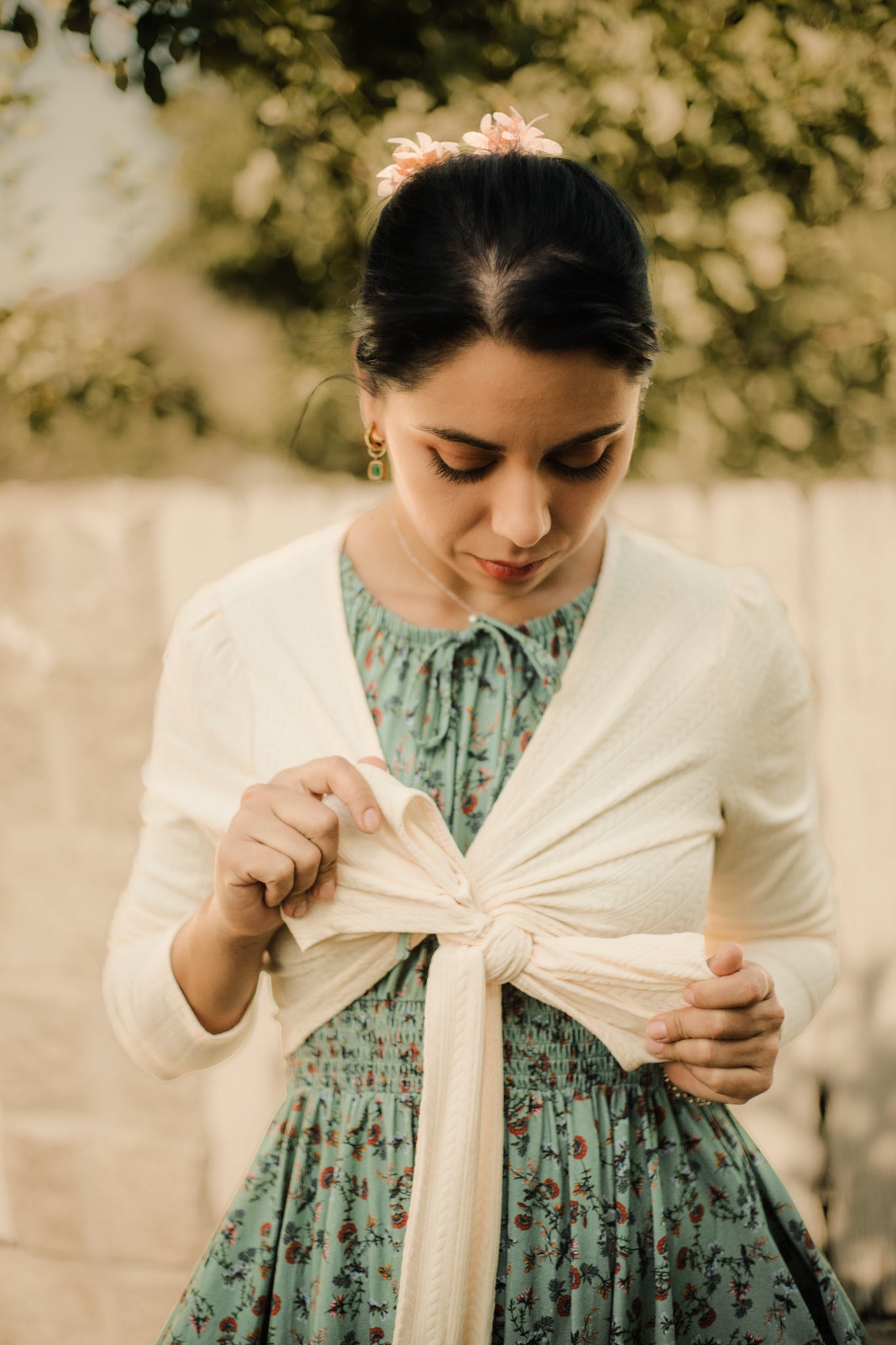 Woman in modest nursing dress with cardigan outdoors