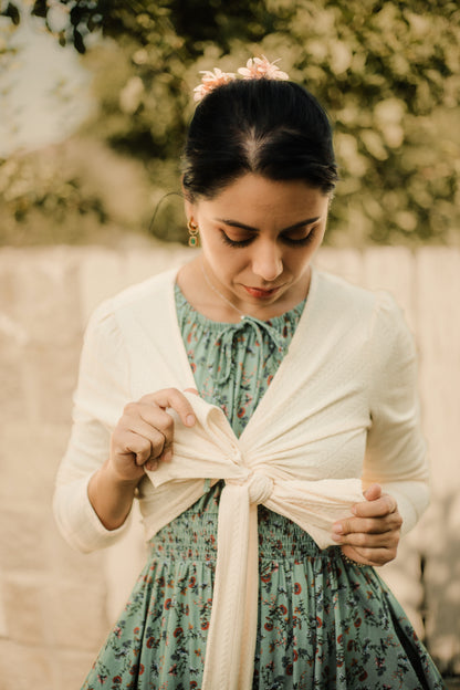 Woman in modest nursing dress with cardigan outdoors