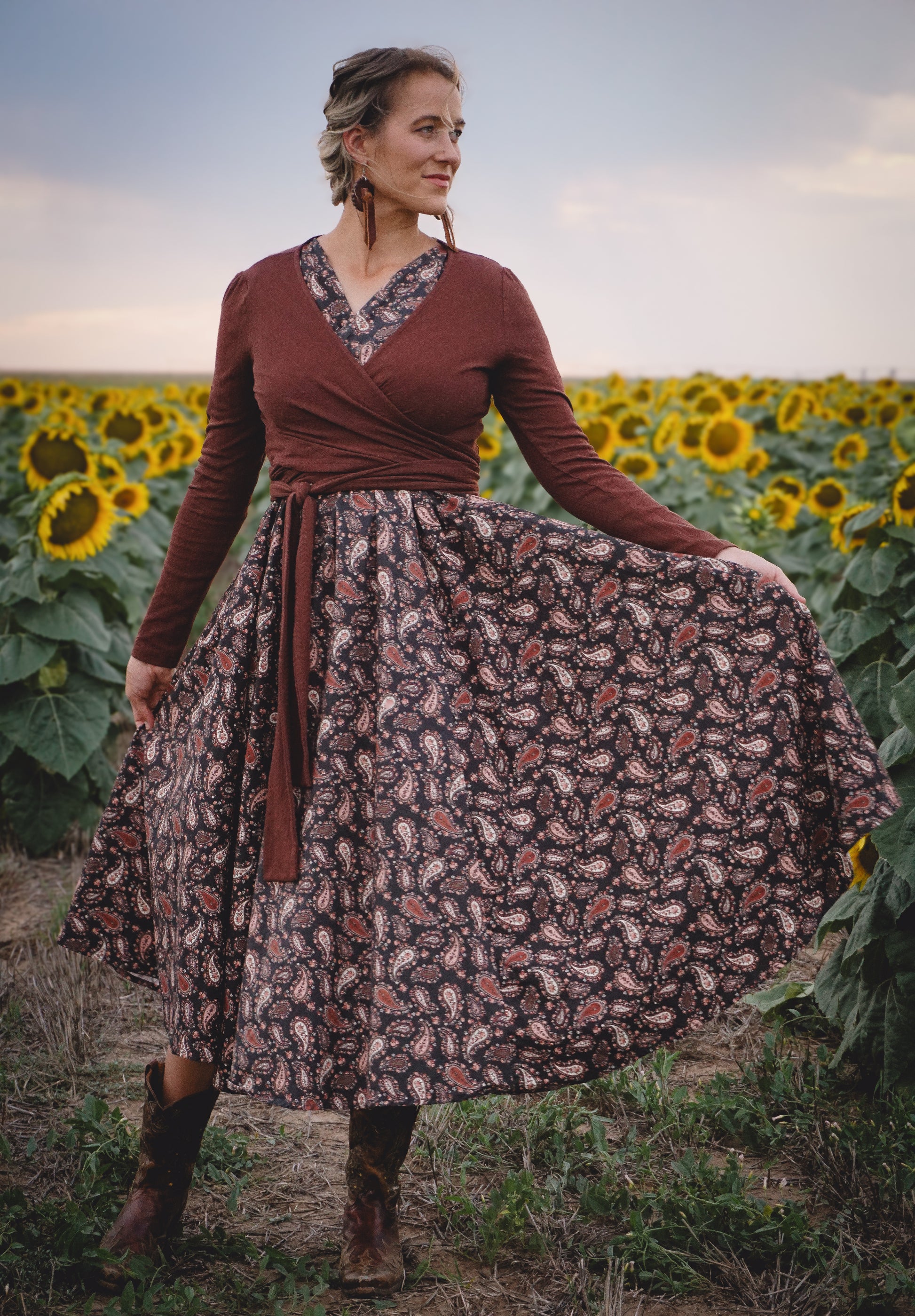 woman in a modest nursing dress in sunflower field