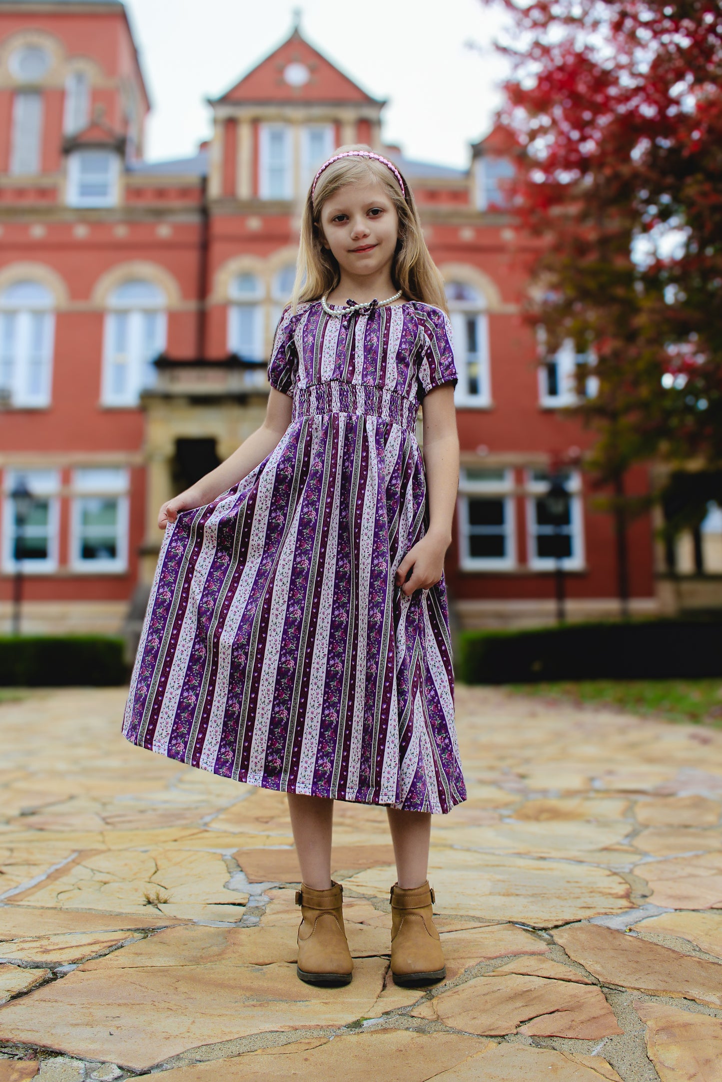 Young girl in modest purple striped dress