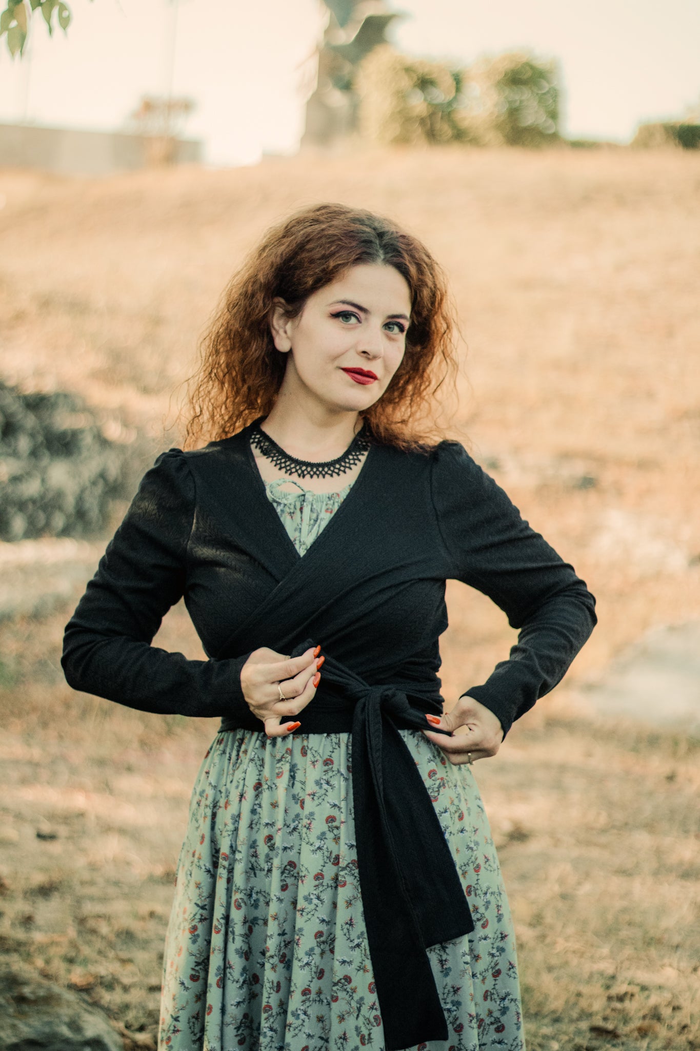 Woman in modest nursing-friendly coat over floral dress outdoors