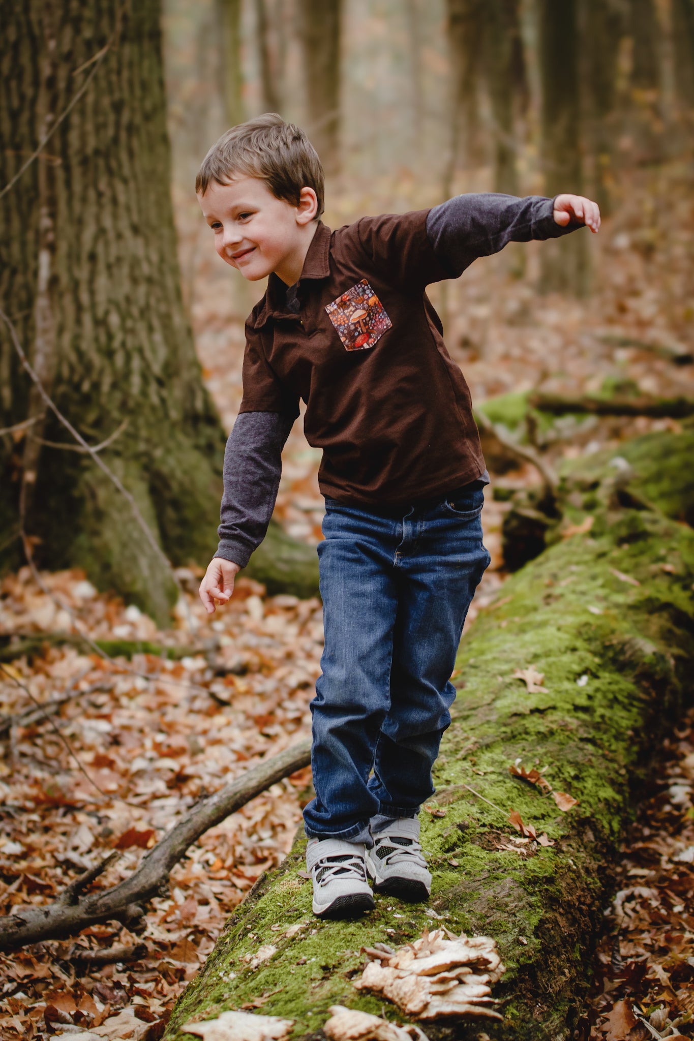 Child balancing on mossy log in forest