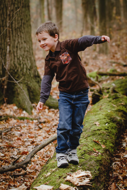 Child balancing on mossy log in forest