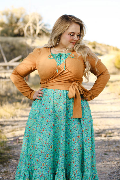 Woman in modest nursing wrap and floral skirt
