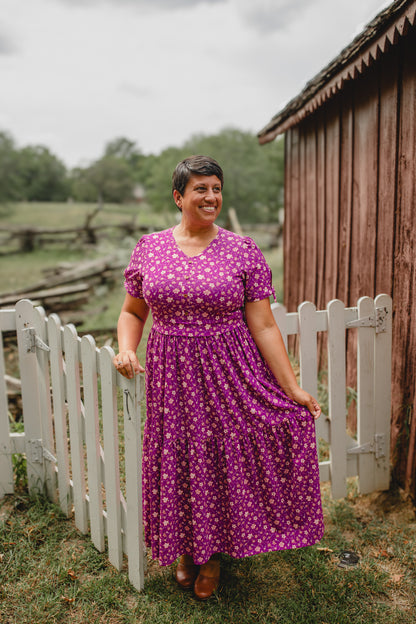Woman in modest nursing dress by fence