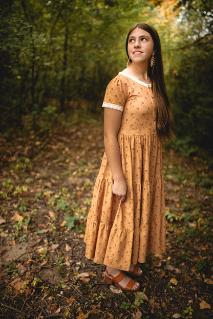 Woman in modest nursing dress in forest