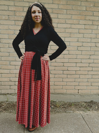 Woman in modest nursing-friendly black top and red plaid skirt