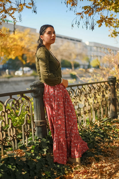 Woman in modest nursing red floral skirt outdoors