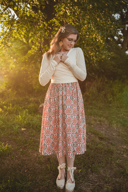 Woman wearing a patterned modest nursing dress