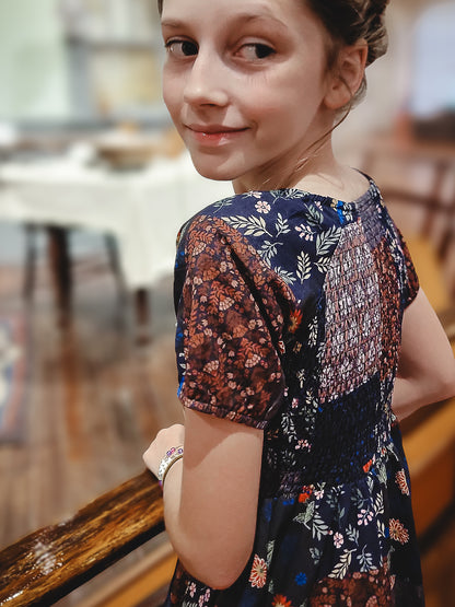young girl wearing a cute patchwork dress