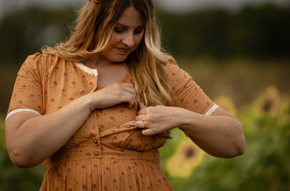 Woman in modest nursing dress sunflower field