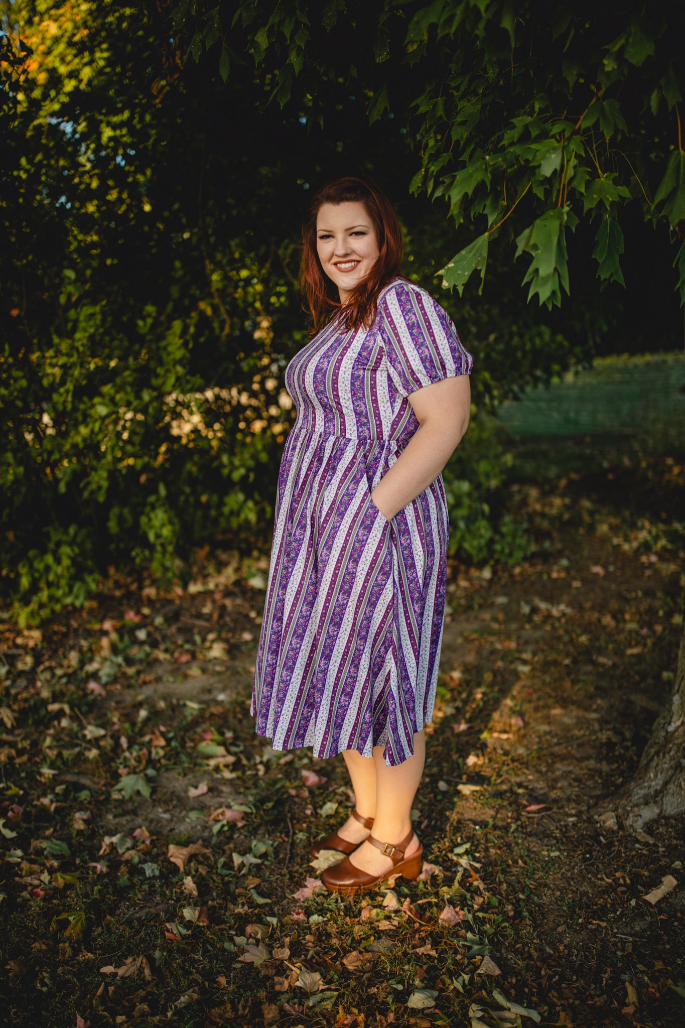 woman wearing a modest nursing purple and white striped dress