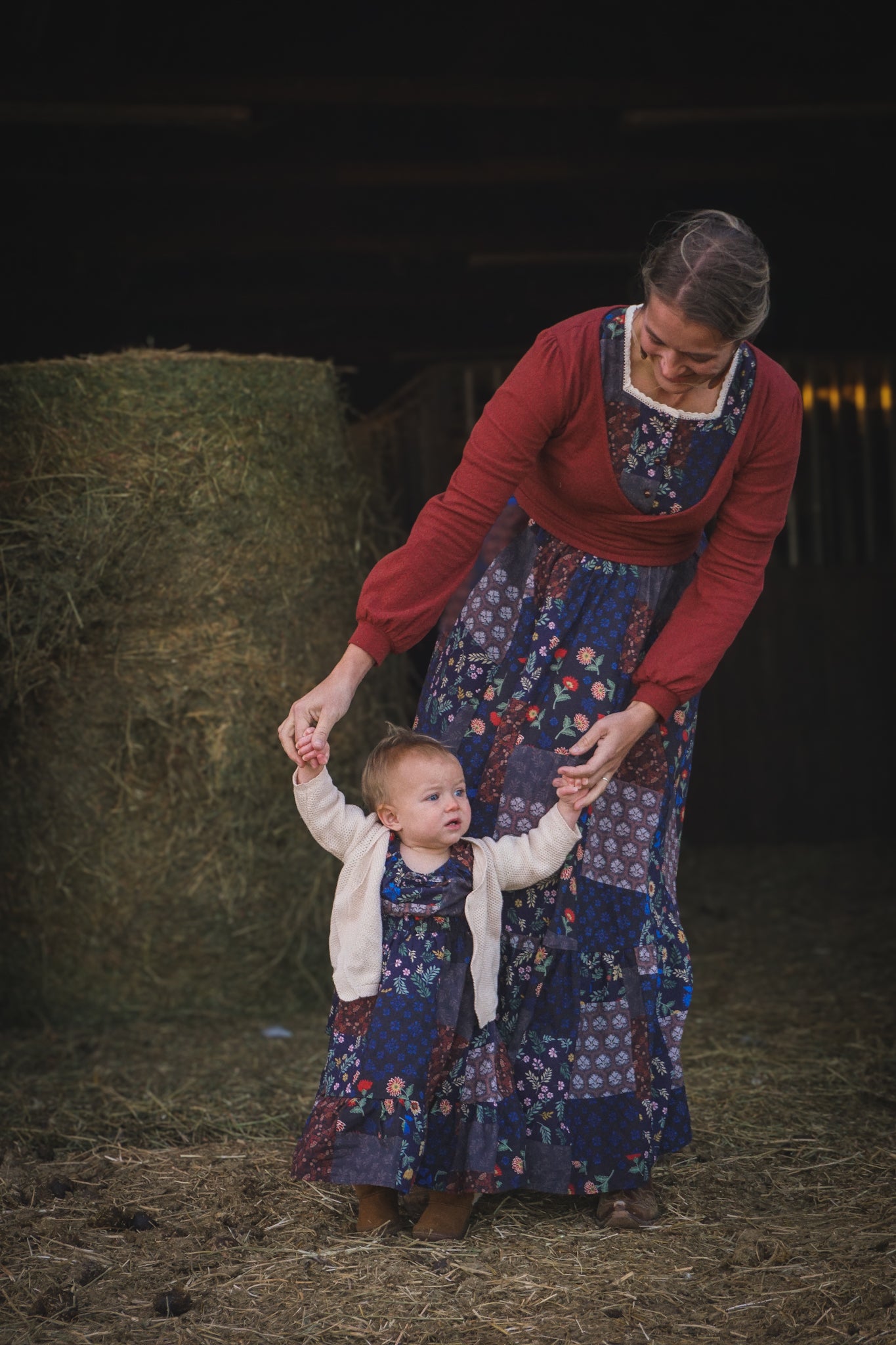 mother wearing a modest nursing patterned dress with her daughter