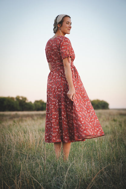 Woman in modest nursing red floral dress outdoors