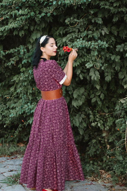 Woman in modest purple floral nursing dress outdoors