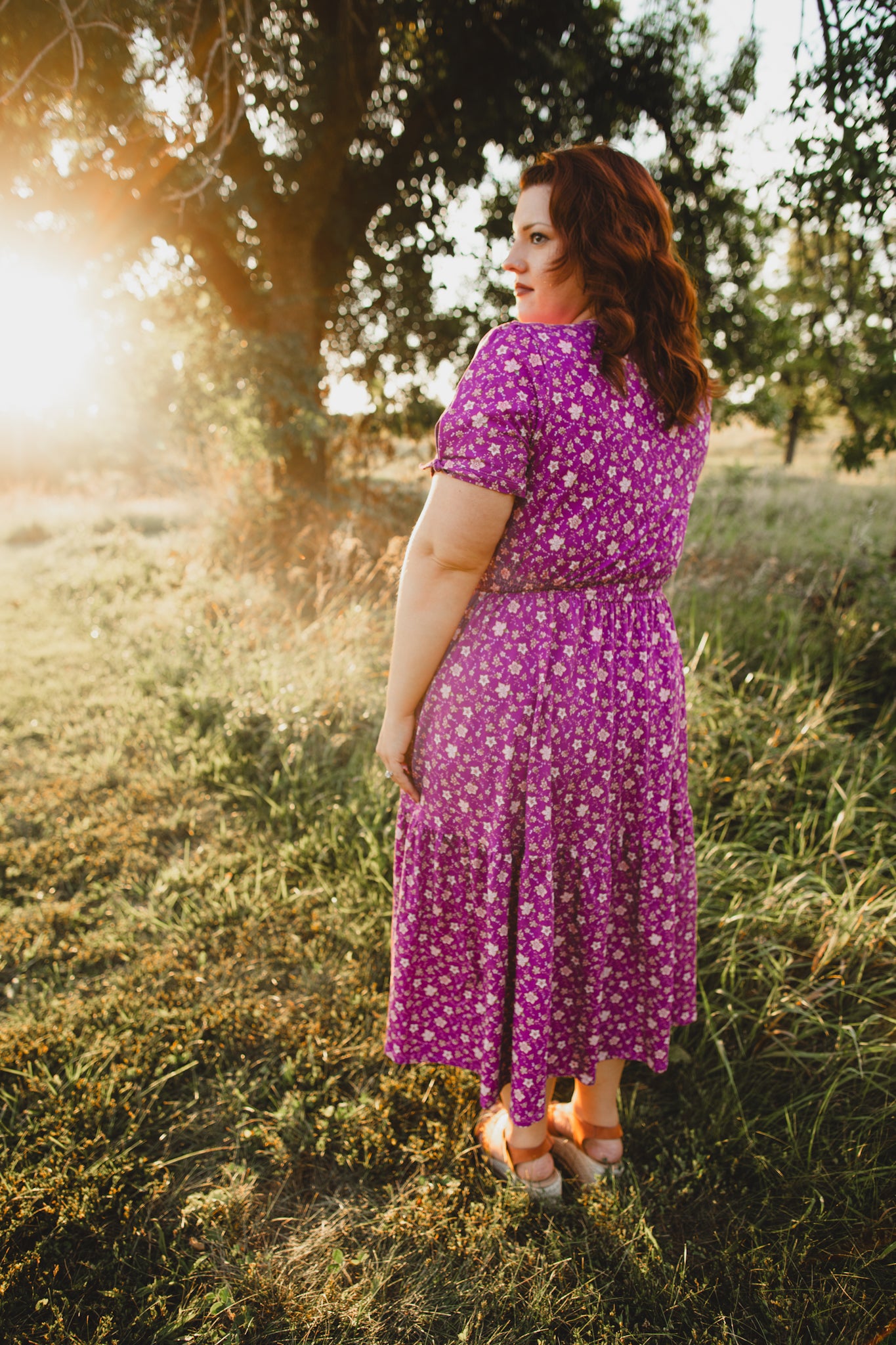 Woman in modest nursing floral dress in field