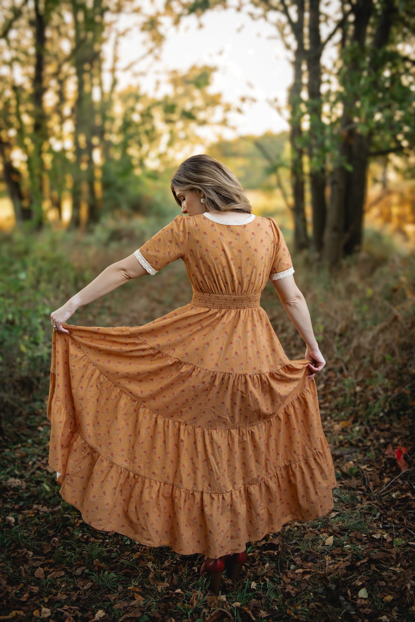 Woman in modest nursing dress forest sunset