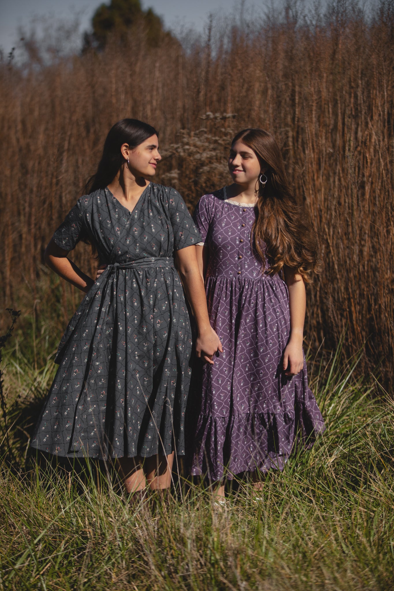 Two modest nursing-friendly patterned dresses in field
