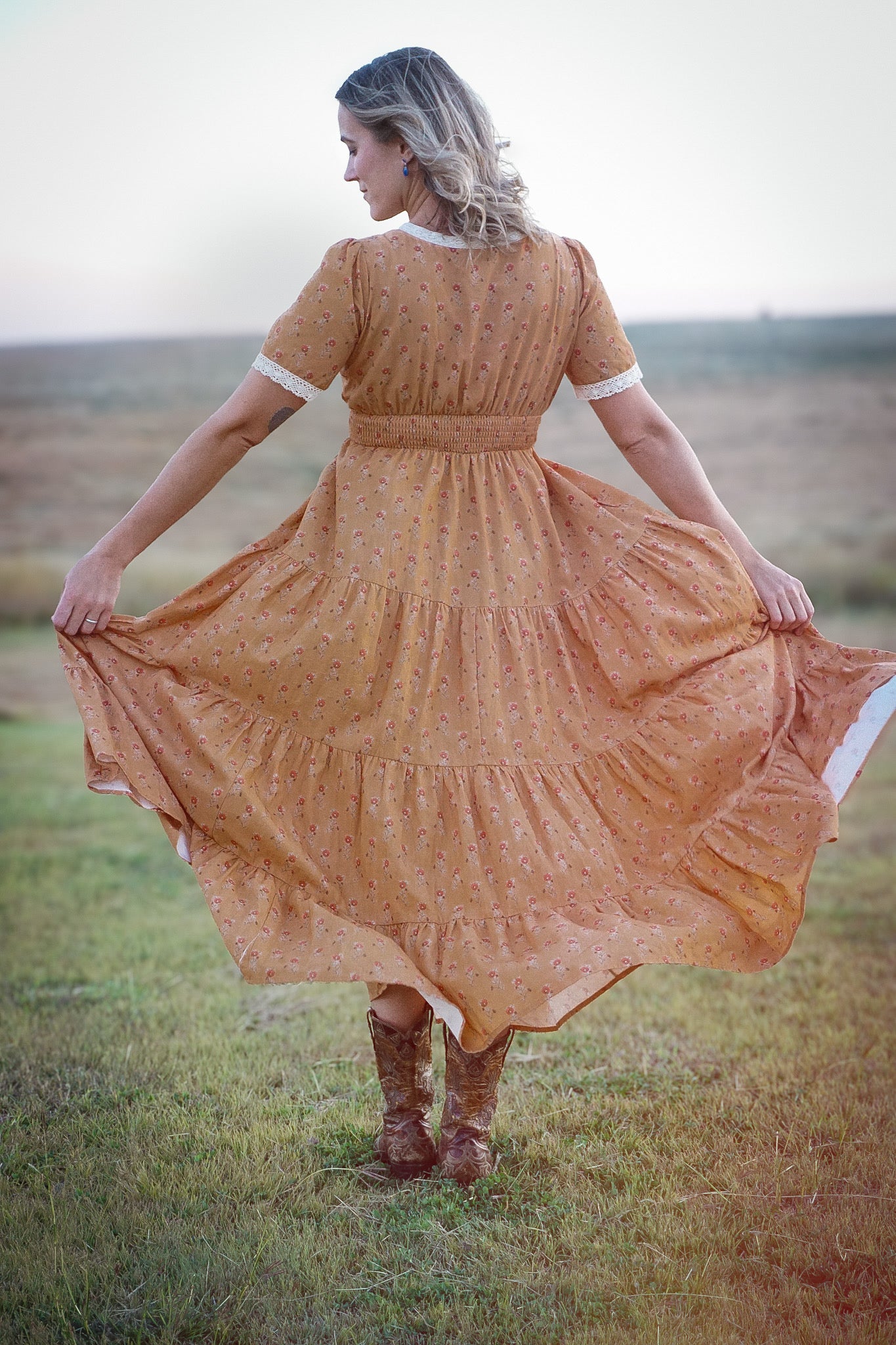 Woman in modest nursing dress standing in field