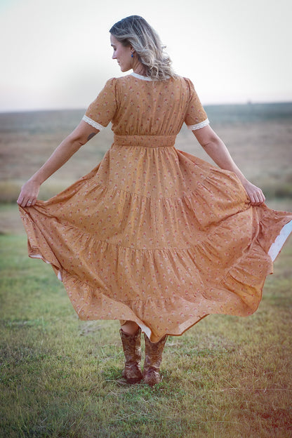 Woman in modest nursing dress standing in field