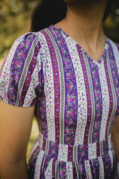 woman wearing a modest nursing purple and white striped dress