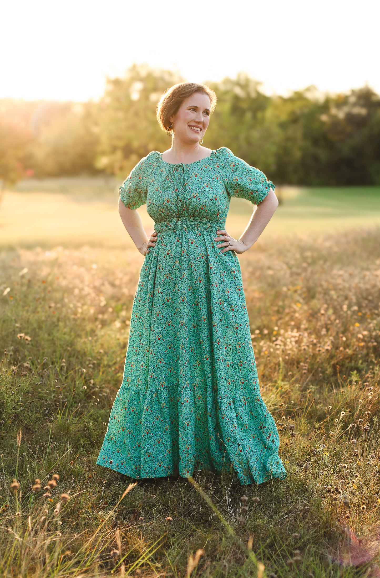 Woman in modest nursing green dress at sunset