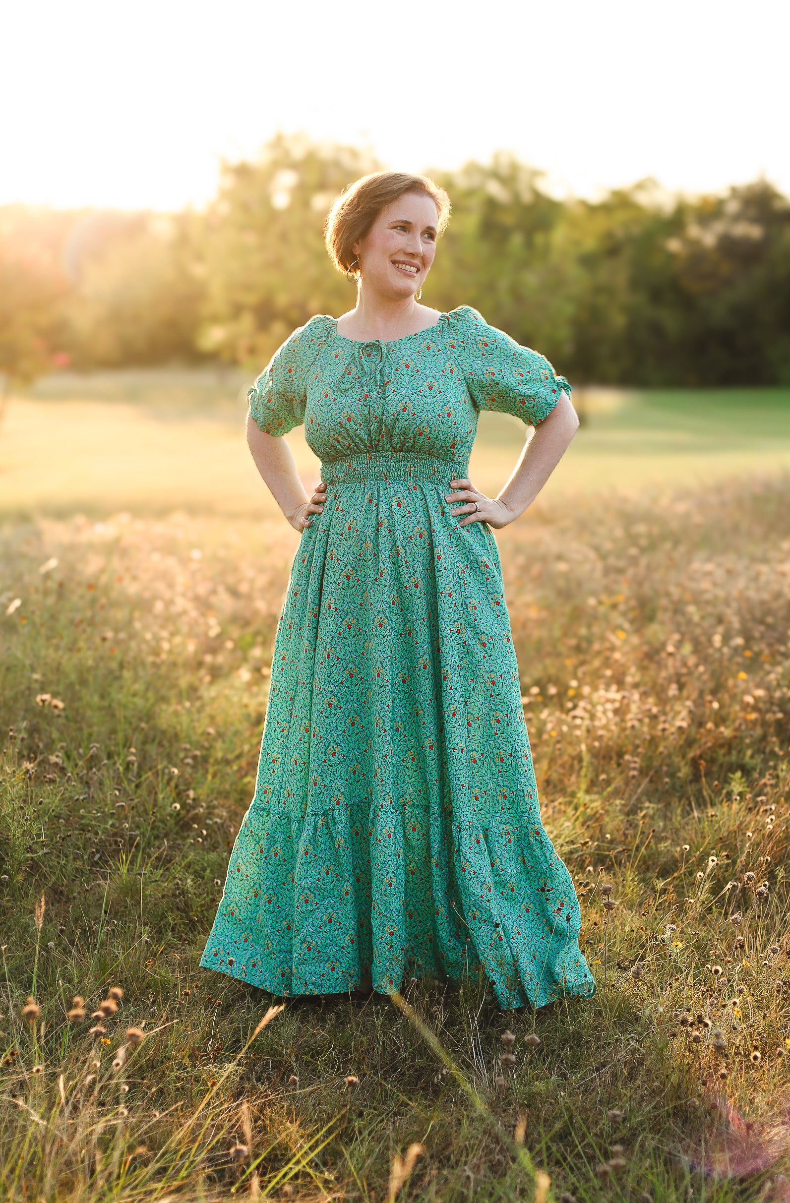 Woman in modest nursing green dress at sunset