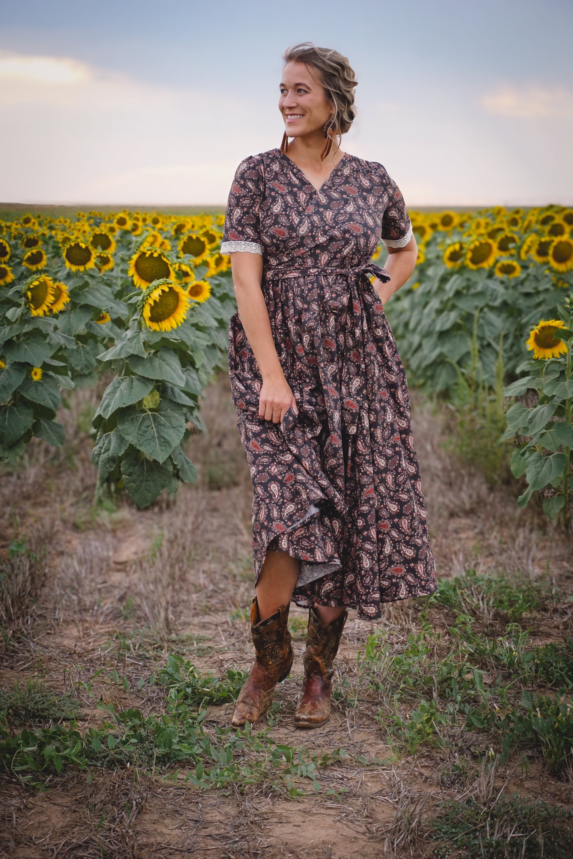 Woman in modest nursing dress in sunflower field