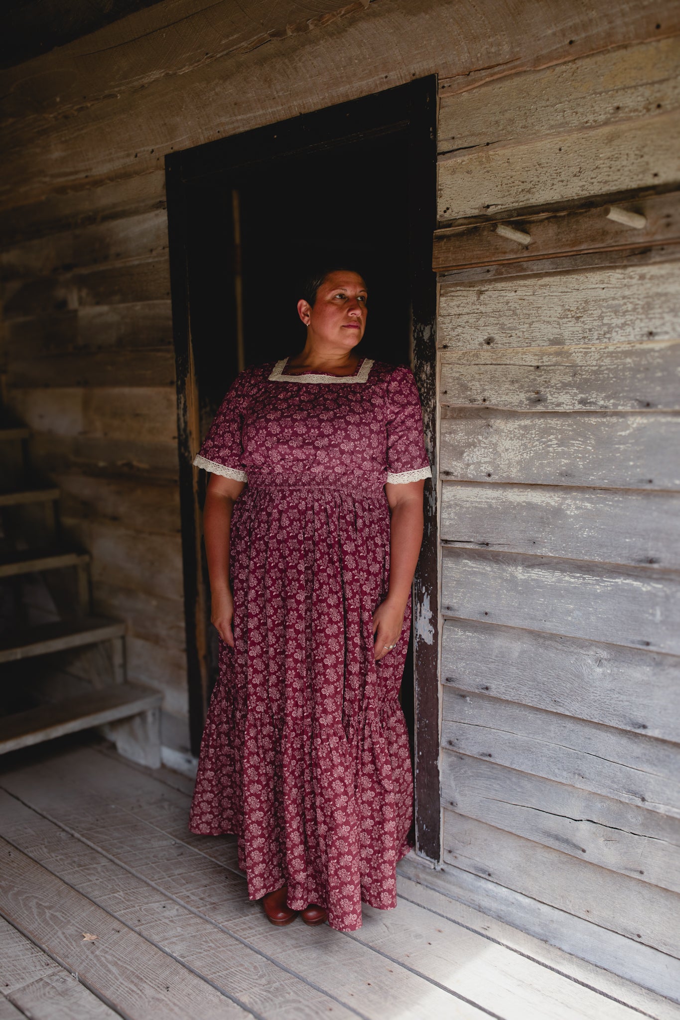 Woman in modest nursing dress inside cabin