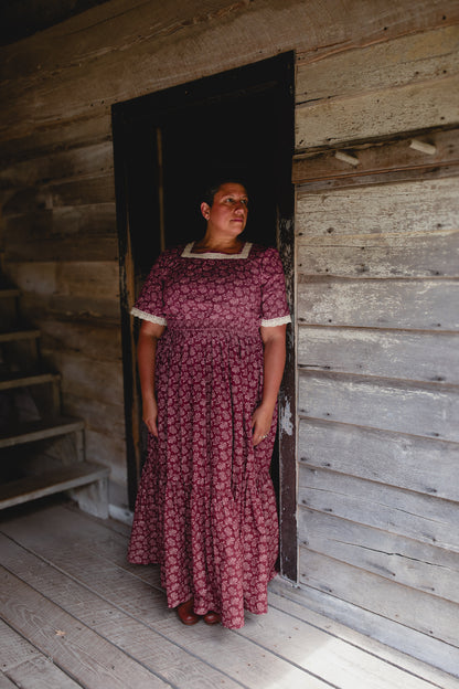 Woman in modest nursing dress inside cabin