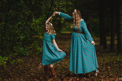 Two women in matching modest nursing blue dresses