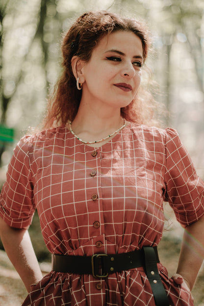 Woman in modest nursing checkered dress outdoors