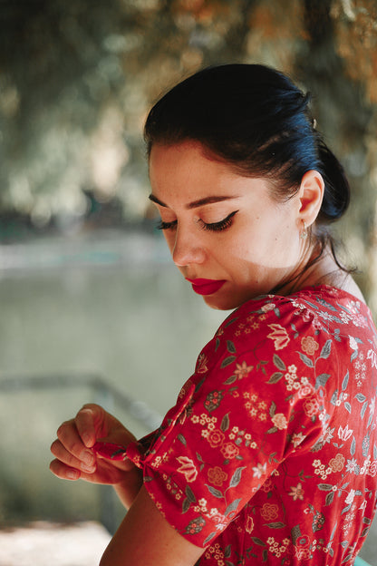 Woman in modest nursing red floral dress outdoors